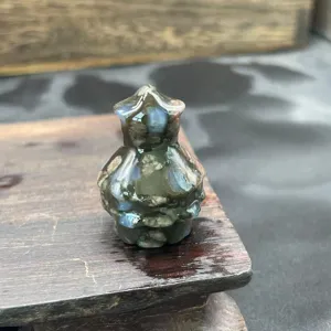 Close-up detail of a miniature natural stone crystal Christmas tree carving decoration.
