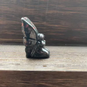 Close up detail view of hand carved natural gemstone crystal fairy figurine ornament