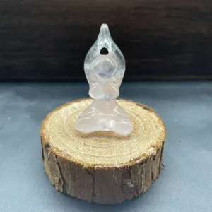 Close-up detail of the natural crystal yoga woman figurine showing fine pink stone texture.