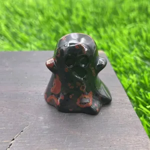 Detailed close up view of natural stone carved ghost figurine, crystal mineral specimen decor.
