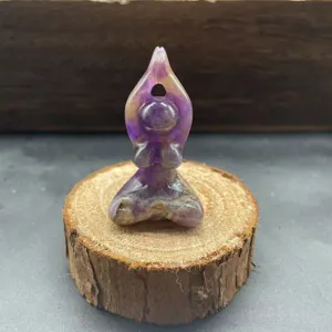 Detail view of a natural stone yoga woman crystal carving sculpture, exquisite handicraft.