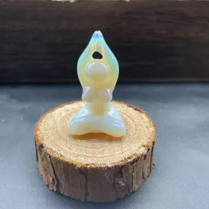 Detail shot of a glowing opalite crystal yoga woman figurine meditating on a rustic wood slice prop.