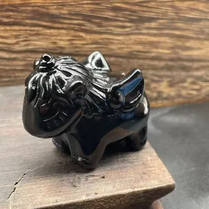 Close-up detail view of hand-carved obsidian crystal unicorn figurine showing fine texture.