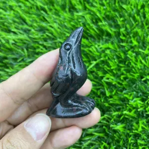Natural gemstone carved raven crystal bird figurine miniature black stone animal art sculpture detail view