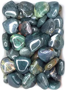 Detailed closeup of polished natural crystal heart stones, showing rich green moss agate textures.