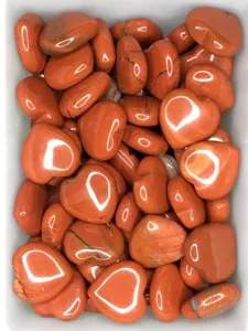 Detailed close-up of natural red gemstone heart crystals, polished smooth texture, crystal decor.
