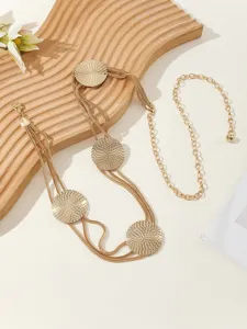 Gold multi-strand chain belt detail view, elegant metal waist accessory for dresses and suits.