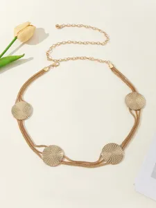 Close-up detail of the elegant gold metal chain waist belt with delicate round mesh decorative discs.