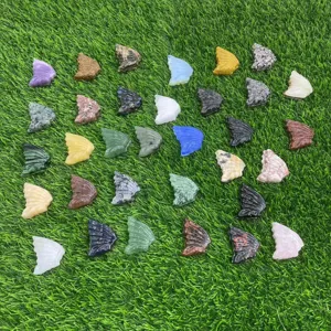 Detailed shot of assorted natural crystal butterfly wings in various colors and gemstone materials.