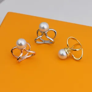 Detailed view of elegant pearl metal scarf clips and adjustable rings in three colors.