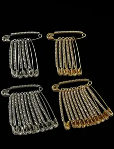 Detailed view of rhinestone decorative safety pins brooch sets in silver and gold colors.