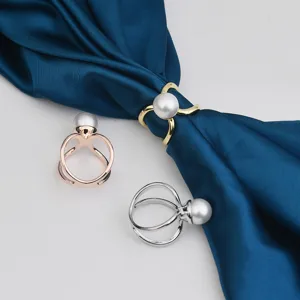 Detail view of the elegant metal pearl silk scarf rings and adjustable fashion accessories.