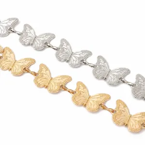 Detailed close-up of metallic butterfly chain links, featuring gold and silver fashion belt accessories.
