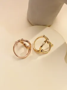 Detailed shot of elegant metal scarf rings in gold and rose gold, modern design accessory.