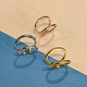 Minimalist metal silk scarf buckle with double ring design, elegant versatile fashion accessory.