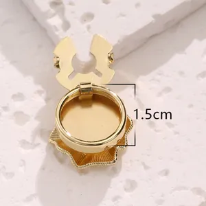 Gold metal button cover cufflink detail close up view, delicate lace tray design, 1.5cm size.
