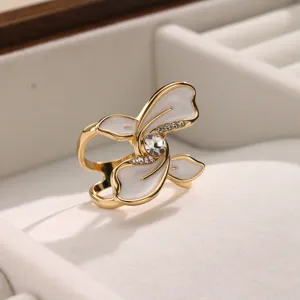 Close-up detail of the gold-tone oil-drop flower scarf buckle with sparkling crystal rhinestones.