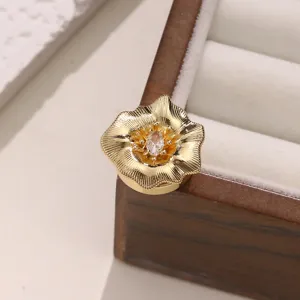 Exquisite gold flower button cover with sparkling central cubic zirconia for luxury shirt.
