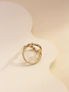 Close-up detail of the elegant gold metallic scarf ring, minimalist design for daily wear.