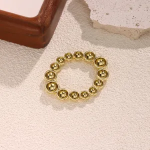 Gold bead scarf buckle detailed view, showing smooth metallic finish and elegant circular design.
