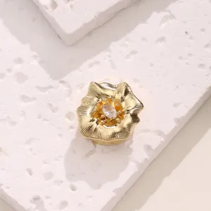 Exquisite gold flower button cover featuring central sparkling zircon detail for elegant shirt styling.