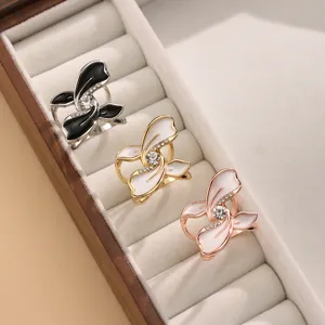 Detailed close-up showing exquisite metal flower scarf clips with sparkling rhinestones and enamel.