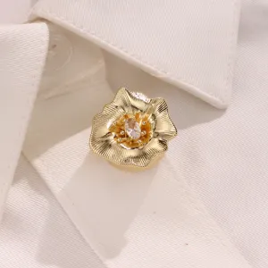Gold flower button cover with sparkling cubic zirconia, elegant metal shirt accessory decor.