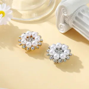 Exquisite pearl and rhinestone button covers, detailed close-up shot of elegant decorative shirt snap buttons.