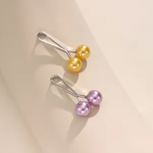 Close-up detail of stylish dual pearl U-shaped hijab pins and scarf fixing clips in nice colors.