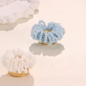 Handcrafted beaded flower button cover detail shot, exquisite shirt accessory decor piece.