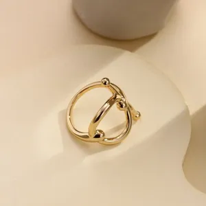 Elegant gold knot silk scarf buckle French minimalist metal ring accessory for stylish outfits