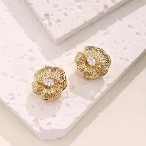 Close-up detail view of gold-tone filigree flower button cover featuring central clear zircon.