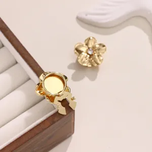 Gold flower button cover with sparkling zircon inlay for shirts and suits detail view.