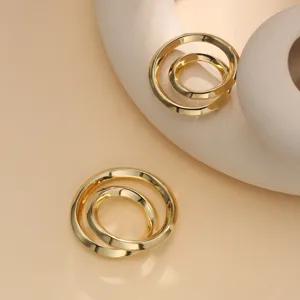 Close-up view of the minimalist interlocking double ring metal clothing clip, elegant.