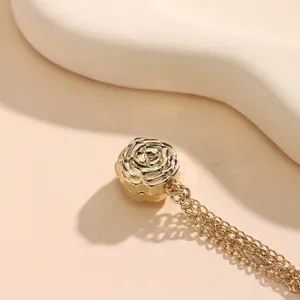 Gold magnetic rose flower clothing buckle detail, multi-chain waist and sleeve tightener tool.