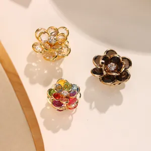 Detailed view of exquisite camellia flower button covers with sparkling crystals for shirt decoration.