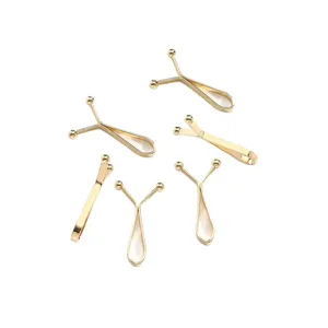 Clips de vêtement métalliques dorés en Y pour hijab, anti-regards et serrage de taille.