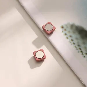 Detail shot of pink square magnetic buttons for hijabs and stylish clothing accessories.