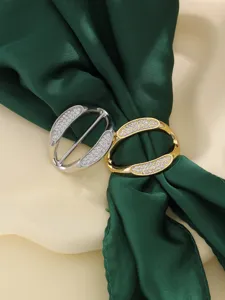 Close-up view of shiny rhinestone clothing corner buckle and alloy scarf ring detail.