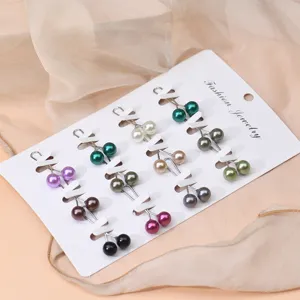 Detailed view of multi-color pearl hijab pins set, elegant U-shaped metal scarf clips for women.