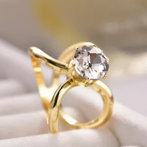 Gold-tone metal silk scarf ring buckle featuring a large clear crystal round cut.