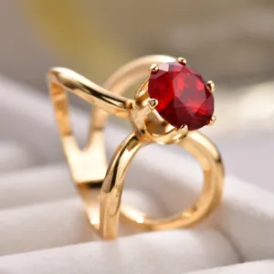 Elegant gold-tone ring with a vibrant red gemstone and unique open band design for daily wear.