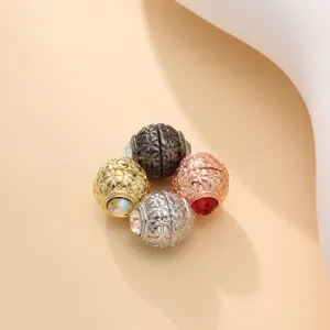 Detailed view of multi-functional magnetic scarf buckle with shiny crystal and textured design.