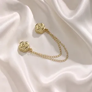 Gold rose magnetic clothing buckle detail, elegant metal chain clip for T-shirt hem and scarf.