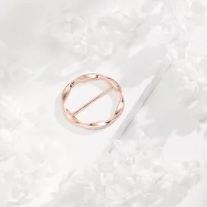 Rose gold minimalist twisted round scarf ring detail shot, elegant clothing accessory.
