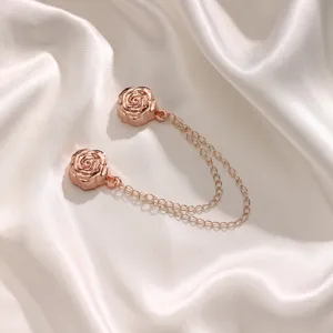Rose gold magnetic clothing clip set with delicate chains for stylish t-shirt and pant hems.