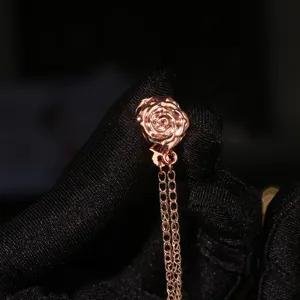 Rose gold flower magnetic buckle clothing accessory, elegant decorative brooch with hanging chains.