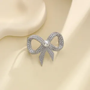 Elegant silver-tone crystal bow pearl scarf buckle and versatile shawl clip for women.