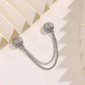 Close-up detail shot of a silver retro magnetic scarf buckle with double chain design.