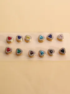 Detailed close-up of multi-color triangular rhinestone magnetic scarf clips and buttons.
